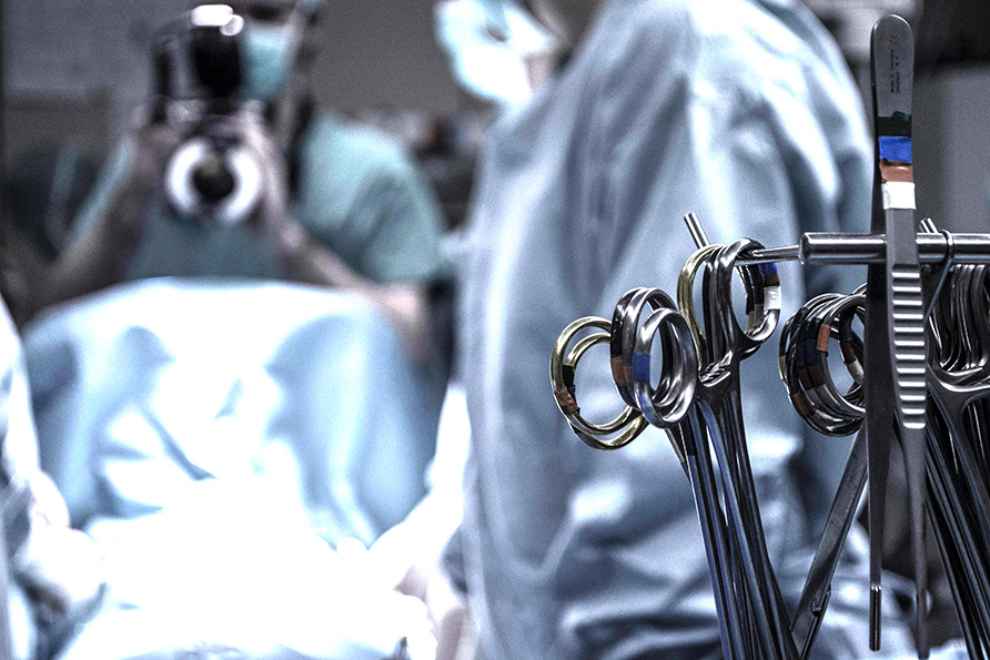 Close up of surgery scissors with surgeons in the background