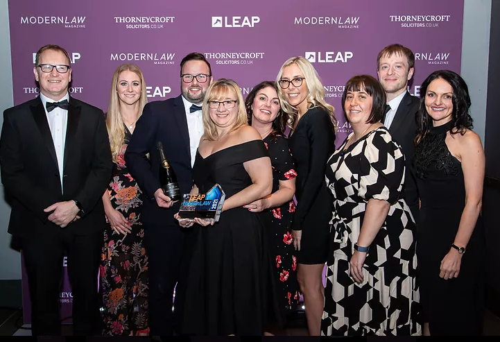 A photo of some of the Birchall Blackburn Law conveyancing team dressed to the nines and holding their trophies from the Modern Law Conveyancing Awards!